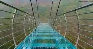 Glass Bridge Rajgir Bihar with tourists walking on transparent glass deck surrounded by lush hills.